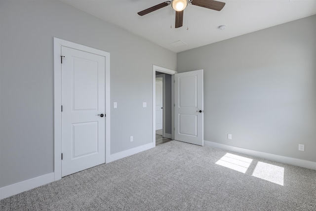 unfurnished bedroom featuring carpet floors and ceiling fan