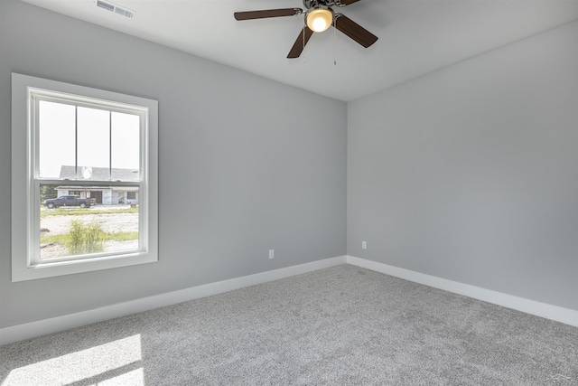 carpeted empty room featuring ceiling fan