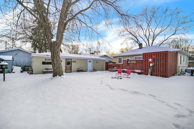 snow covered property featuring a wooden deck