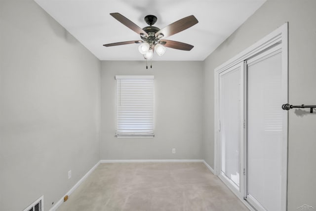 unfurnished bedroom featuring light carpet, a closet, and ceiling fan