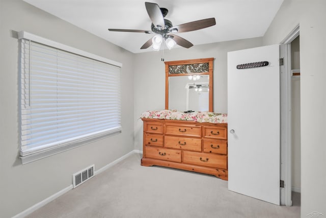 bedroom with ceiling fan and light carpet