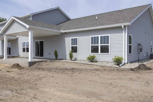 rear view of property featuring central AC and a patio area