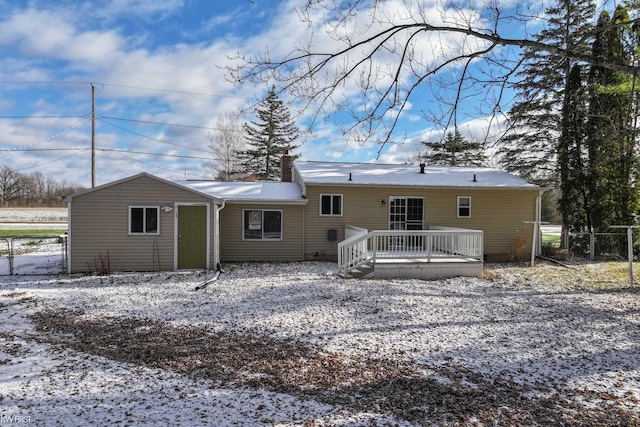 snow covered property featuring a deck