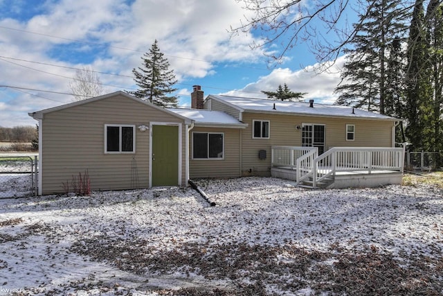 snow covered property with a deck