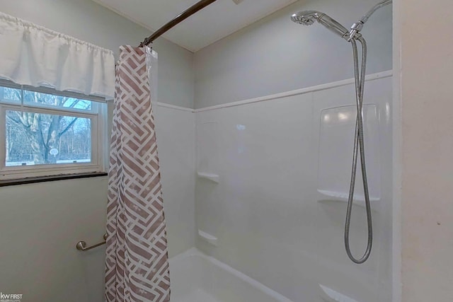 bathroom with shower / bath combo with shower curtain