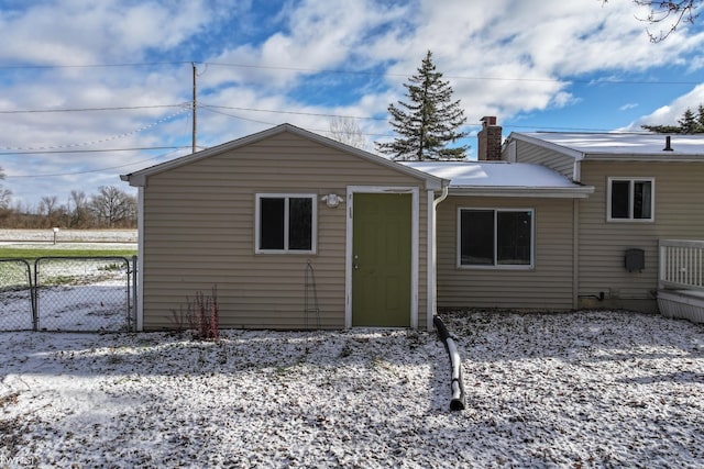 view of snow covered rear of property