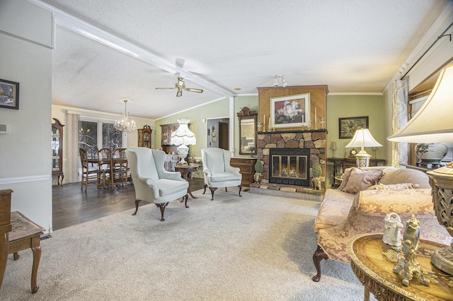 living room with lofted ceiling with beams, crown molding, a textured ceiling, a fireplace, and ceiling fan with notable chandelier