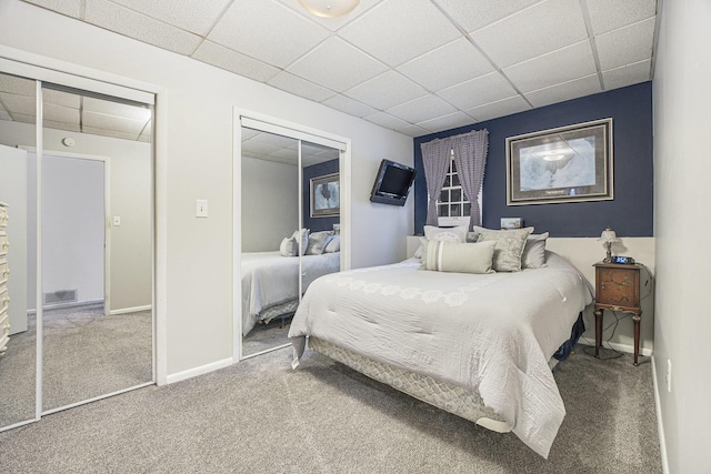 bedroom with carpet, a paneled ceiling, and a closet