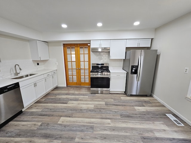 kitchen with white cabinets, sink, stainless steel appliances, and french doors