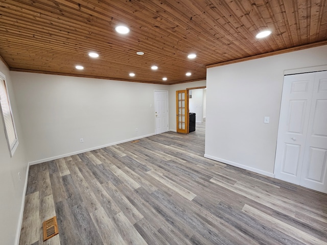 basement featuring ornamental molding, wood ceiling, french doors, and wood-type flooring