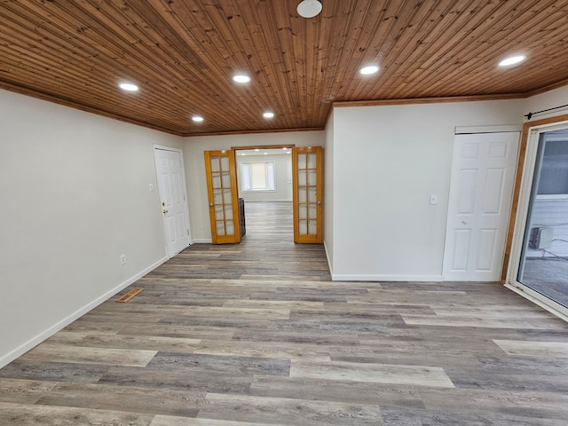 spare room featuring french doors, hardwood / wood-style flooring, crown molding, and wooden ceiling