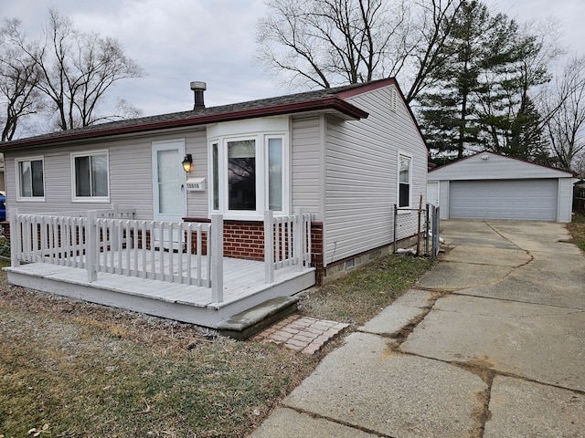 view of front of property featuring a garage and an outdoor structure