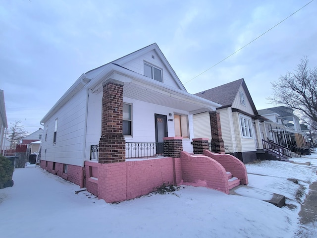 view of snow covered exterior with a porch