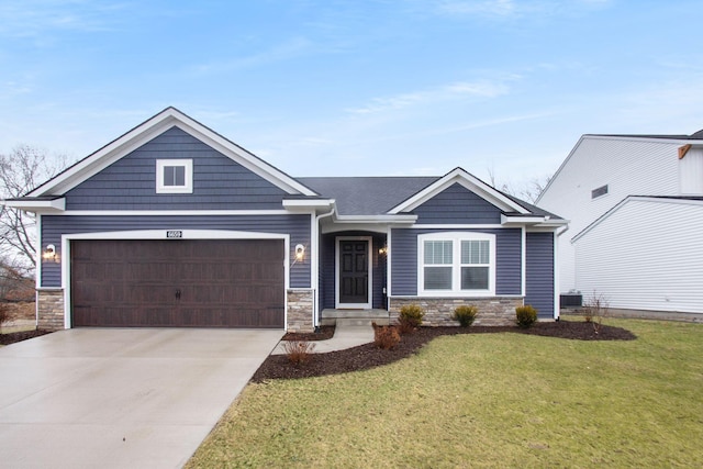 craftsman-style home with a garage and a front lawn