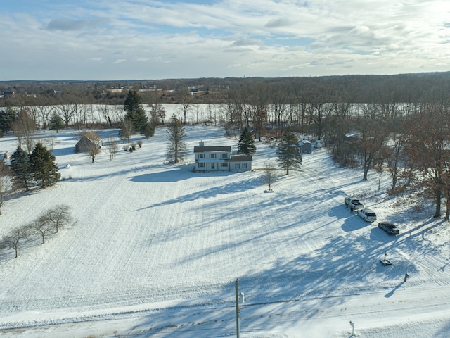 snowy aerial view featuring a rural view