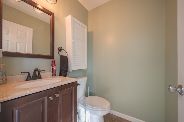 bathroom with tile patterned floors, vanity, and toilet