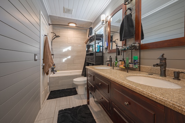 full bathroom featuring tile patterned flooring, vanity, toilet, and tiled shower / bath