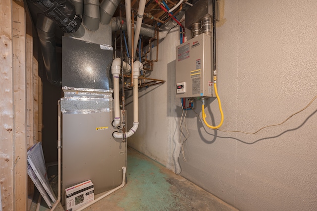 utility room featuring tankless water heater