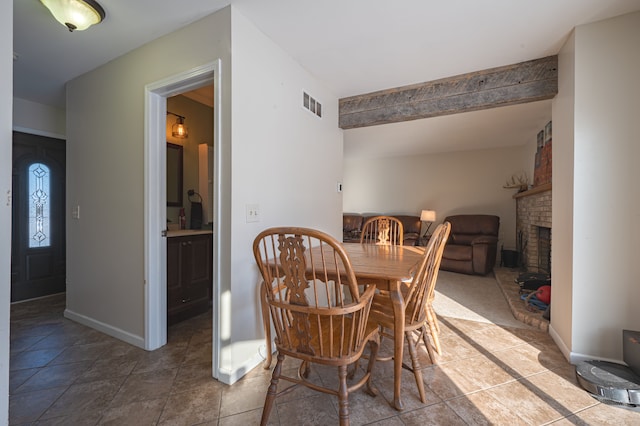 tiled dining space featuring a fireplace