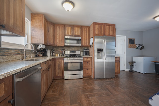 kitchen featuring backsplash, dark parquet floors, sink, and stainless steel appliances