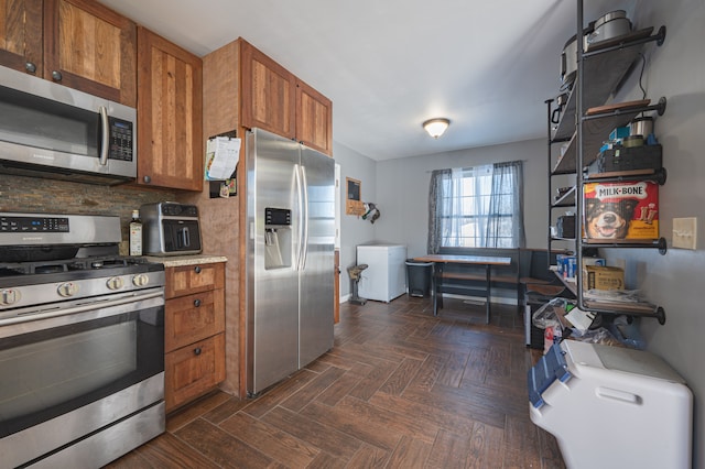 kitchen with backsplash, dark parquet floors, and stainless steel appliances