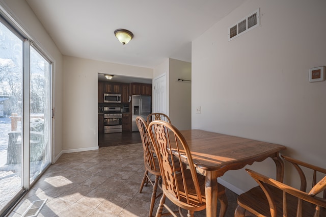 dining area with light tile patterned floors