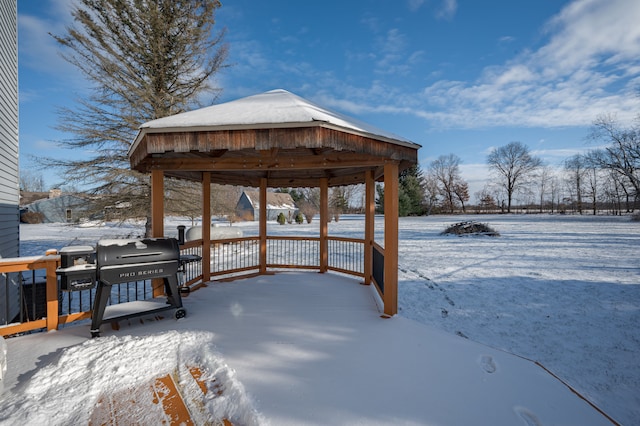 snow covered deck featuring a gazebo and area for grilling