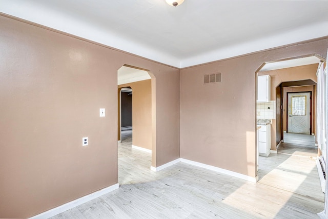 spare room with light hardwood / wood-style flooring