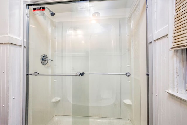 bathroom featuring a shower with door