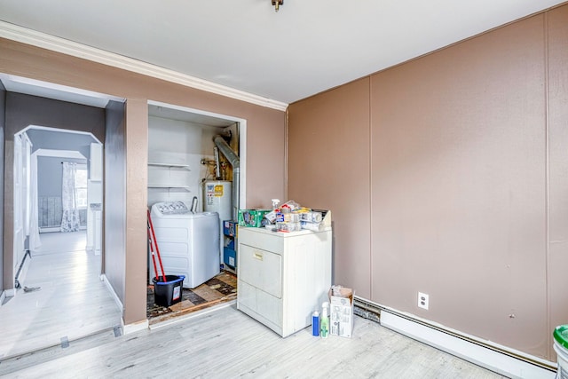 clothes washing area featuring washing machine and clothes dryer, crown molding, light hardwood / wood-style flooring, and a baseboard heating unit