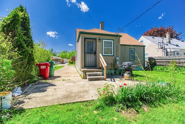 rear view of house featuring a yard