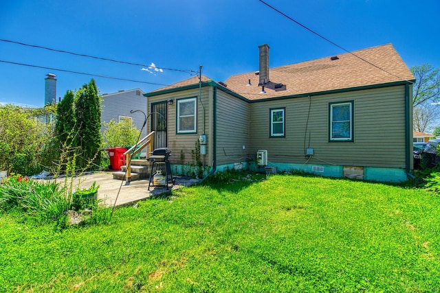 back of house featuring a lawn and a patio