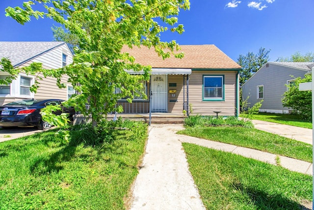 bungalow-style home with a front lawn