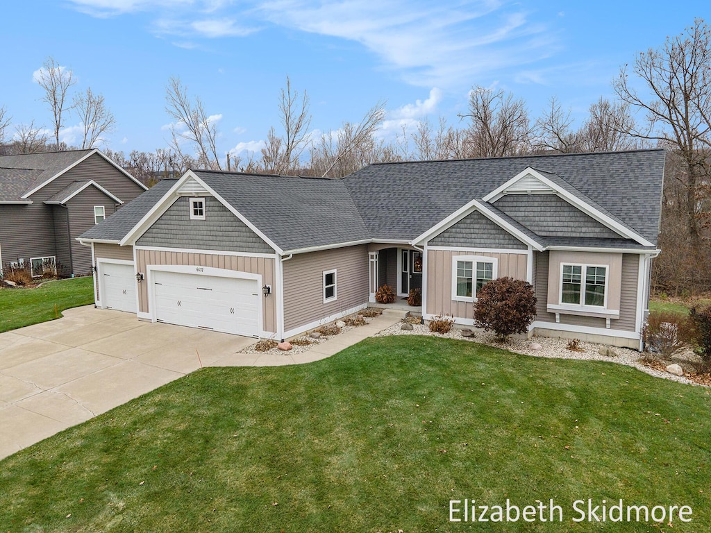 view of front of house with a front yard and a garage