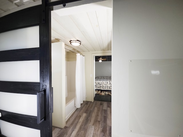 corridor with hardwood / wood-style flooring and wood ceiling