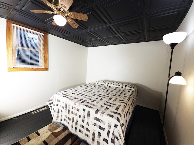 bedroom with ceiling fan and hardwood / wood-style floors