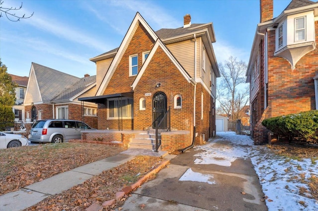 16148 Roselawn St, Detroit, MI 48221 - tudor house with brick siding, an outdoor structure, and a chimney