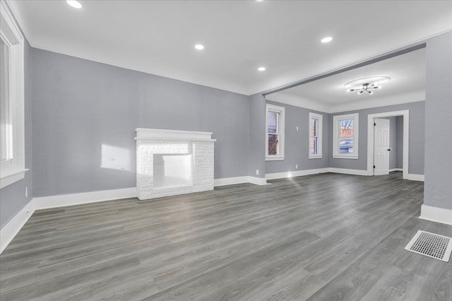 16148 Roselawn St, Detroit, MI 48221 - unfurnished living room with a brick fireplace, wood finished floors, and recessed lighting