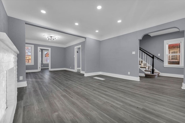 16148 Roselawn St, Detroit, MI 48221 - unfurnished living room featuring dark wood-style flooring, stairs, and recessed lighting