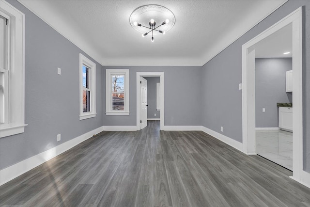 16148 Roselawn St, Detroit, MI 48221 - spare room with a textured ceiling, dark wood finished floors, and a chandelier