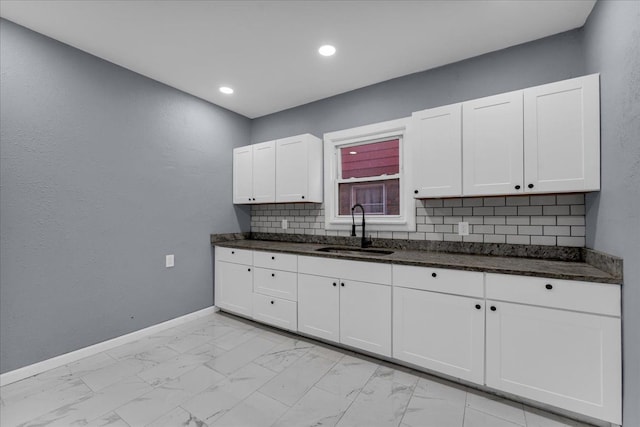 16148 Roselawn St, Detroit, MI 48221 - kitchen featuring light marble finish floors, white cabinets, dark stone countertops, and recessed lighting