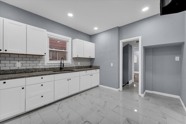 16148 Roselawn St, Detroit, MI 48221 - kitchen with white cabinets, tasteful backsplash, light marble finish floors, dark stone counters, and recessed lighting