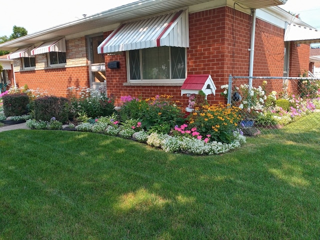 view of side of home with a lawn