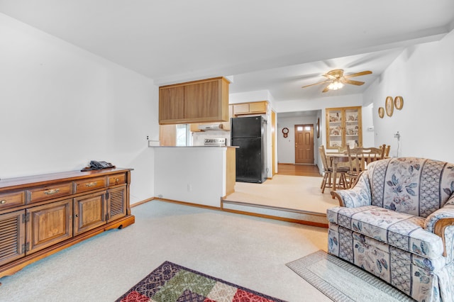 carpeted living room featuring ceiling fan