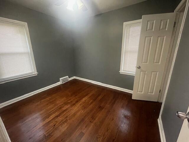 spare room featuring ceiling fan and dark hardwood / wood-style floors