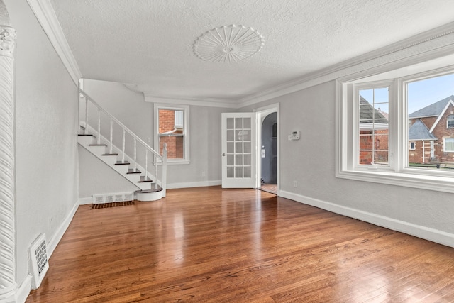 interior space with crown molding, hardwood / wood-style floors, and a textured ceiling