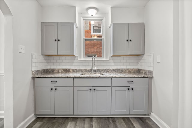 kitchen featuring decorative backsplash, gray cabinets, dark hardwood / wood-style floors, and sink