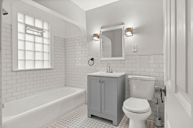 bathroom with tile patterned flooring, vanity, tile walls, and toilet