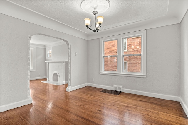 interior space with hardwood / wood-style floors, a chandelier, and a textured ceiling