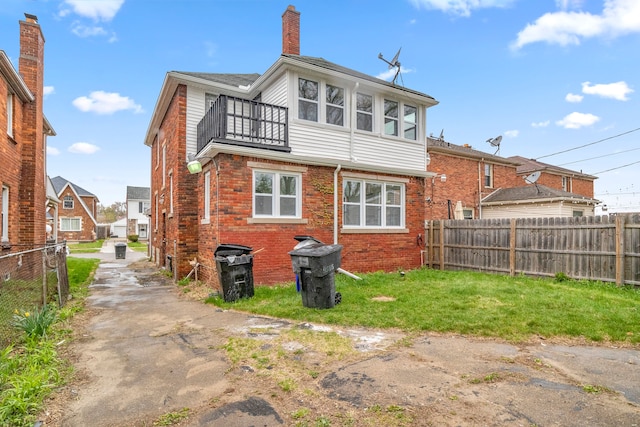 back of house featuring a balcony